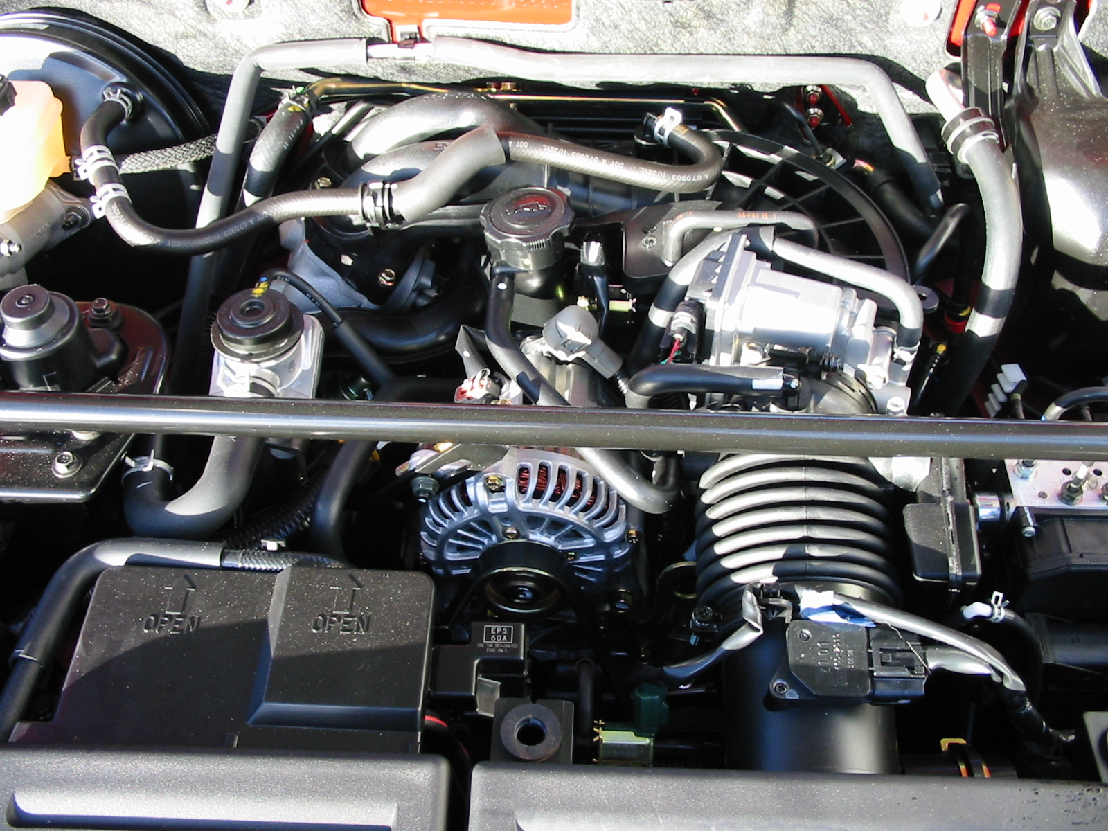 Mazda_rx-8_engine_bay_with_cover_removed.jpg